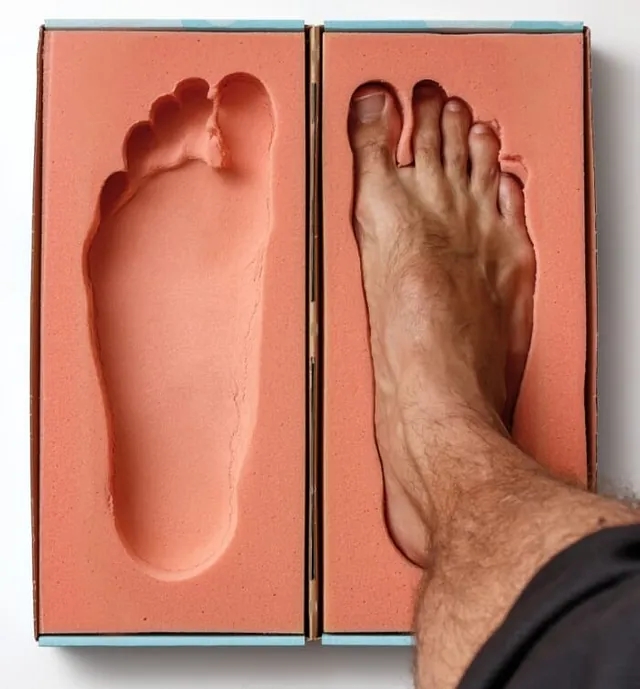 A foot placed inside a treatment box, illustrating pinched nerve therapy in Millsboro & Seaford, DE