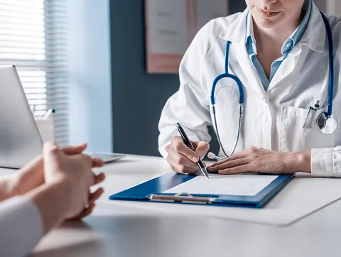 Podiatrist Explaining Patient Post Procedure Care